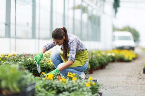 Team member preparing equipment at the start of a garden maintenance job