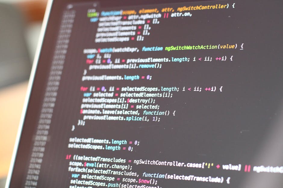 A close-up view of a computer screen displaying lines of colorful programming code, including keywords, variables, and functions in shades of blue, pink, and green on a dark background. The focus is o