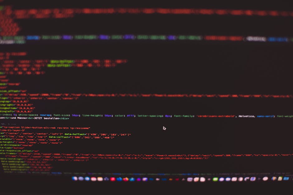 A close-up view of a computer screen displaying lines of colorful programming code, including keywords, variables, and functions in shades of blue, pink, and green on a dark background. The focus is o